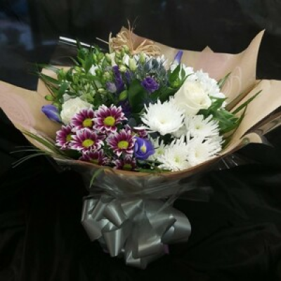 Prostate Cancer UK - Our 50th Anniversary Year Handtied Bouquet in water is dedicated to Prostate Cancer UK.  Created using a range of Blue, White and Lilac seasonal blooms.  From each bouquet ordered, Maureen's Florist will donate a minimum of £2.50 to Prostate Cancer UK, a charity we are supporting for the duration of our 50th Year.